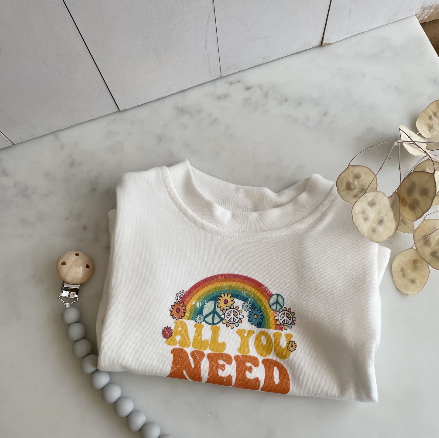 all you need is love t-shirt for baby. orange colour. milk white t-shirt. organic. super soft baby clothing 